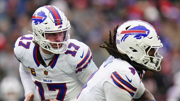 Dec 14, 2025; Foxborough, Massachusetts, USA; Buffalo Bills quarterback Josh Allen (17) fakes the hand off to running back James Cook III (4) against the New England Patriots in the second half at Gillette Stadium. Mandatory Credit: David Butler II-Imagn Images