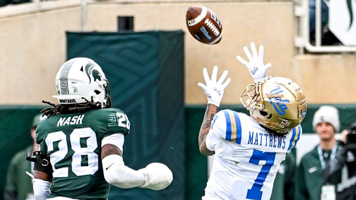 UCLA's Mikey Matthews, right, catches a pass as Michigan State's Dontavius Nash defends during the second quarter on Saturday, Oct. 11, 2025, at Spartan Stadium in East Lansing. UCLA's Mikey Matthews, right, catches a pass as Michigan State's Dontavius Nash defends during the second quarter on Saturday, Oct. 11, 2025, at Spartan Stadium in East Lansing.