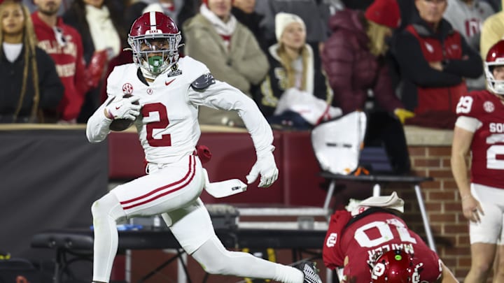 Dec 19, 2025; Norman, OK, USA; Alabama Crimson Tide defensive back Zabien Brown (2) eludes a tackle by Oklahoma Sooners quarterback John Mateer (10) in the first half at Gaylord Family OK Memorial Stadium. Mandatory Credit: Mark J. Rebilas-Imagn Images