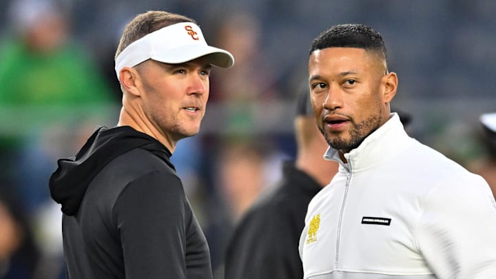 Oct 14, 2023; South Bend, Indiana, USA; USC Trojans head coach Lincoln Riley and Notre Dame Fighting Irish head coach Marcus Freeman chat before the game at Notre Dame Stadium. 