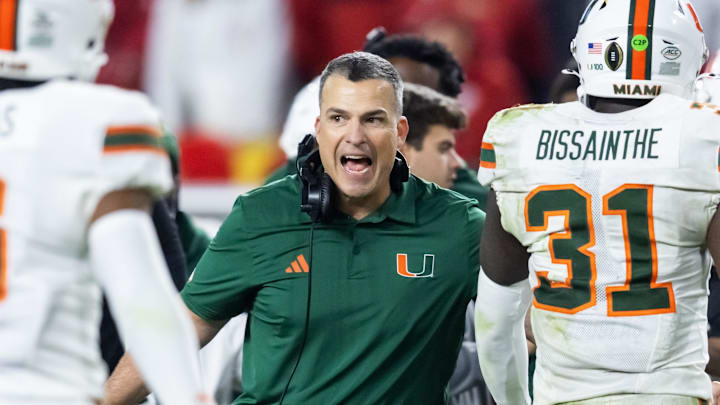 Jan 19, 2026; Miami Gardens, FL, USA; Miami Hurricanes head coach Mario Cristobal with linebacker Wesley Bissainthe (31) against the Indiana Hoosiers during the College Football Playoff National Championship game at Hard Rock Stadium. Mandatory Credit: Mark J. Rebilas-Imagn Images