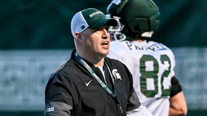 Michigan State's head coach Pat Fitzgerald, left, slaps hands with NiJhay Burt during spring football practice on Tuesday, April 14, 2026, in East Lansing. Michigan State's head coach Pat Fitzgerald, left, slaps hands with NiJhay Burt during spring football practice on Tuesday, April 14, 2026, in East Lansing.