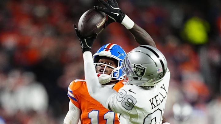 Nov 6, 2025; Denver, Colorado, USA; Las Vegas Raiders cornerback Kyu Blu Kelly (36) intercepts a pass for Denver Broncos wide receiver Troy Franklin (11) during the first half at Empower Field at Mile High. Mandatory Credit: Ron Chenoy-Imagn Images Nov 6, 2025; Denver, Colorado, USA; Las Vegas Raiders cornerback Kyu Blu Kelly (36) intercepts a pass for Denver Broncos wide receiver Troy Franklin (11) during the first half at Empower Field at Mile High. Mandatory Credit: Ron Chenoy-Imagn Images