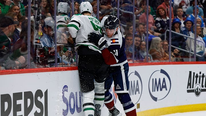Mar 18, 2026; Denver, Colorado, USA; Colorado Avalanche center Brock Nelson (11) and Dallas Stars defenseman Tyler Myers (57) battle for the puck in the second period at Ball Arena. Mandatory Credit: Isaiah J. Downing-Imagn Images