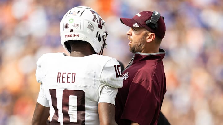 Sep 14, 2024; Gainesville, Florida, USA; Texas A&M Aggies quarterback Marcel Reed (10) celebrates with Texas A&M Aggies offensive coordinator Collin Klein after a touchdown against the Florida Gators during the first half at Ben Hill Griffin Stadium. Mandatory Credit: Matt Pendleton-Imagn Images Sep 14, 2024; Gainesville, Florida, USA; Texas A&M Aggies quarterback Marcel Reed (10) celebrates with Texas A&M Aggies offensive coordinator Collin Klein after a touchdown against the Florida Gators during the first half at Ben Hill Griffin Stadium. Mandatory Credit: Matt Pendleton-Imagn Images