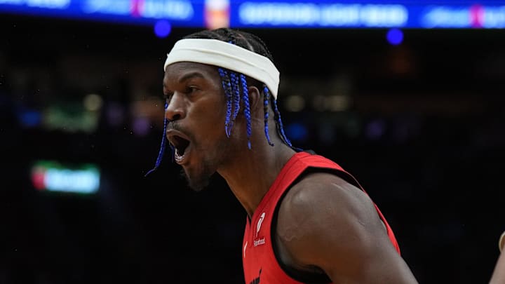 Dec 7, 2024; Miami, Florida, USA;  Miami Heat forward Jimmy Butler (22) celebrates with guard Dru Smith (12) after a three-point-play against the Phoenix Suns during the second half at Kaseya Center. Mandatory Credit: Jim Rassol-Imagn Images