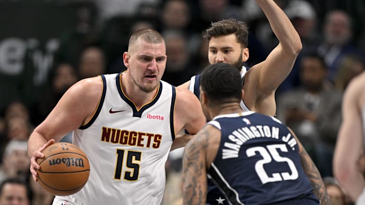 Jan 12, 2025; Dallas, Texas, USA; Denver Nuggets center Nikola Jokic (15) moves the ball past Dallas Mavericks forward Maxi Kleber (42) and forward P.J. Washington (25) during the second quarter at the American Airlines Center. Mandatory Credit: Jerome Miron-Imagn Images Jan 12, 2025; Dallas, Texas, USA; Denver Nuggets center Nikola Jokic (15) moves the ball past Dallas Mavericks forward Maxi Kleber (42) and forward P.J. Washington (25) during the second quarter at the American Airlines Center. Mandatory Credit: Jerome Miron-Imagn Images