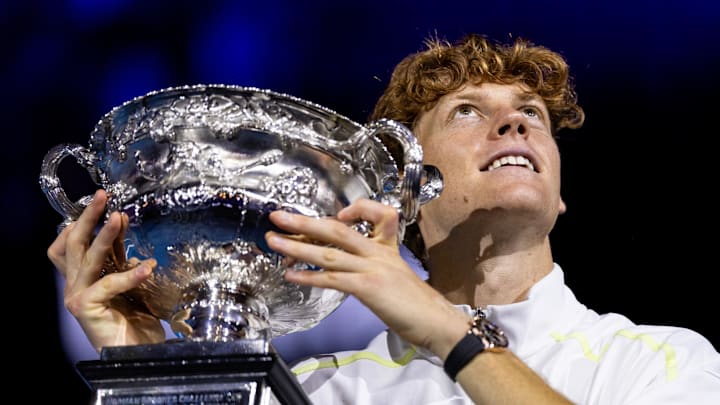 Jannik Sinner poses with the 2025 Australian Open trophy.