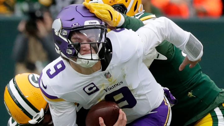 Green Bay Packers linebacker Isaiah McDuffie (58) and defensive tackle Warren Brinson (91) sack Minnesota Vikings quarterback J.J. McCarthy (9) on Sunday, November 23, 2025, at Lambeau Field in Green Bay, Wis. The Packers defeated the Vikings 23-6.