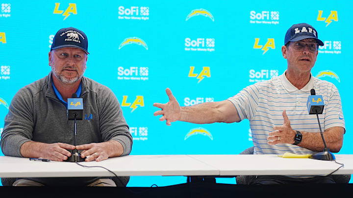 Jan 15, 2025; El Segundo, CA, USA; Los Angeles Chargers general manager Joe Hortiz (left) and coach Jim Harbaugh at a press conference at The Bolt. 