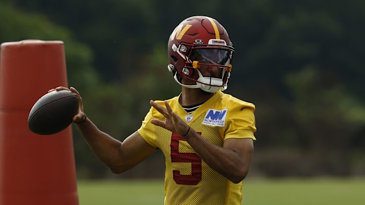 Jul 23, 2025; Ashburn, VA, USA; Washington Commanders quarterback Jayden Daniels (5) passes a ball during practice on day one of training camp at OrthoVirginia Training Center at Commanders Park. Mandatory Credit: Geoff Burke-Imagn Images
