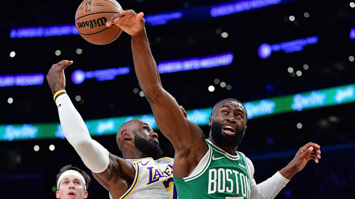 Feb 22, 2026; Los Angeles, California, USA; Boston Celtics guard Jaylen Brown (7) plays for the rebound against Los Angeles Lakers forward LeBron James (23) during the first half at Crypto.com Arena. Mandatory Credit: Gary A. Vasquez-Imagn Images