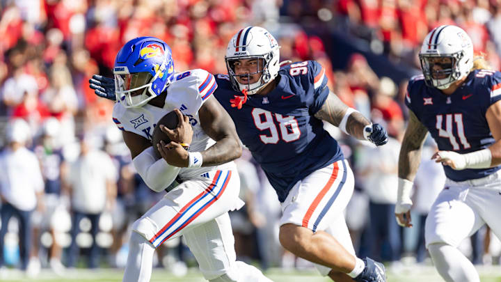 Nov 8, 2025; Tucson, Arizona, USA; Kansas Jayhawks quarterback Jalon Daniels (6) against Arizona Wildcats defensive lineman Tiaoalii Savea (98) at Arizona Stadium. Mandatory Credit: Mark J. Rebilas-Imagn Images