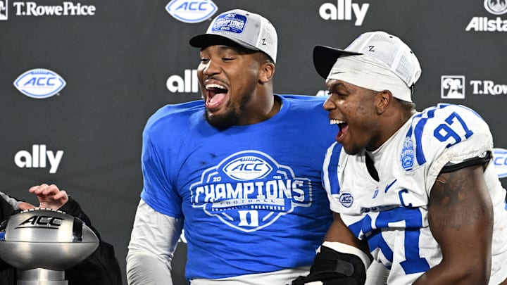 Dec 6, 2025; Charlotte, NC, USA; Duke Blue Devils defensive tackle Aaron Hall (99) and defensive end Wesley Williams (97) celebrate after winning the  ACC Championship game at Bank of America Stadium. Mandatory Credit: Bob Donnan-Imagn Images