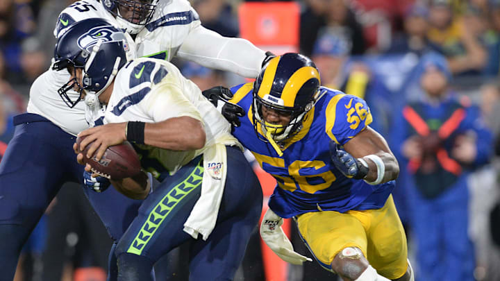 December 8, 2019; Los Angeles, CA, USA; Los Angeles Rams linebacker Dante Fowler (56) moves in against Seattle Seahawks offensive tackle Germain Ifedi (65) to sack quarterback Russell Wilson (3) during the second half at the Los Angeles Memorial Coliseum. Mandatory Credit: Gary A. Vasquez-Imagn Images