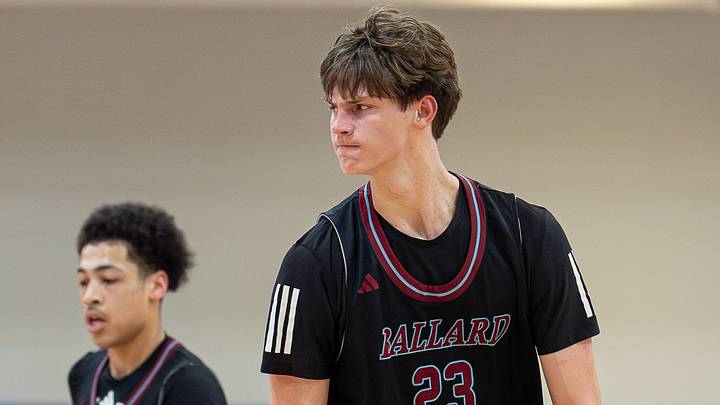 Ballard's Mason Grivna (23) flexes after making a three-pointer.