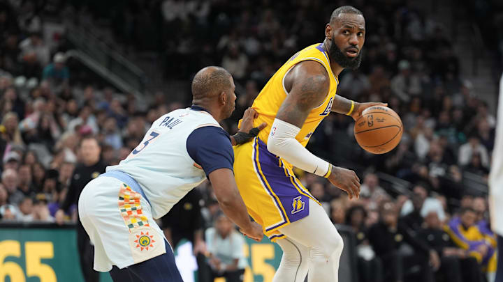 Los Angeles Lakers forward LeBron James (23) dribbles against San Antonio Spurs guard Chris Paul (3) in the second half at Frost Bank Center.