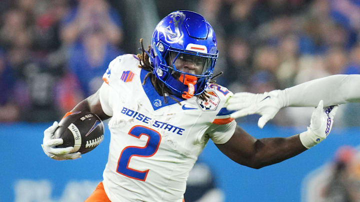 Boise State Broncos running back Ashton Jeanty (2) runs past Penn State Nittany Lions linebacker Kobe King (41) during their Vrbo Fiesta Bowl matchup at State Farm Stadium on Dec. 31, 2024.