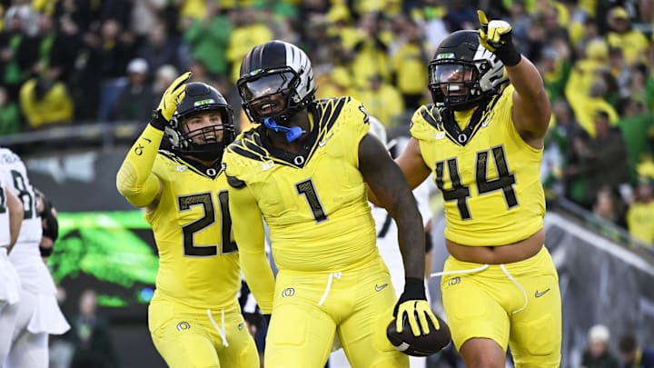 Oct 4, 2024; Eugene, Oregon, USA; Oregon Ducks defensive end Jordan Burch (1) celebrates with teammates linebacker Bryce Boettcher (28) and linebacker Teitum Tuioti (44) after recovering a fumble for a safety during the first half against the Michigan State Spartans at Autzen Stadium. Mandatory Credit: Troy Wayrynen-Imagn Images Oct 4, 2024; Eugene, Oregon, USA; Oregon Ducks defensive end Jordan Burch (1) celebrates with teammates linebacker Bryce Boettcher (28) and linebacker Teitum Tuioti (44) after recovering a fumble for a safety during the first half against the Michigan State Spartans at Autzen Stadium. Mandatory Credit: Troy Wayrynen-Imagn Images