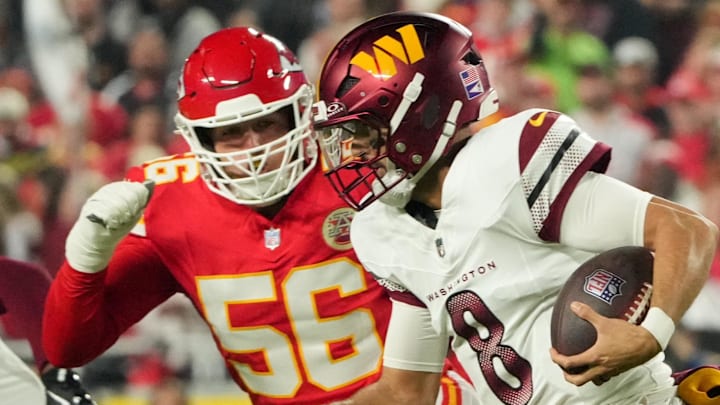 Oct 27, 2025; Kansas City, Missouri, USA; Washington Commanders quarterback Marcus Mariota (8) scrambles with the ball defended by Kansas City Chiefs defensive end George Karlaftis (56) during the first quarter of the game at GEHA Field at Arrowhead Stadium. Mandatory Credit: Denny Medley-Imagn Images