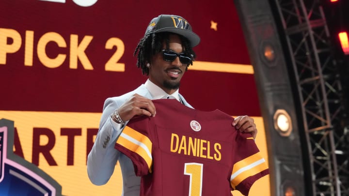 Apr 25, 2024; Detroit, MI, USA; LSU Tigers quarterback Jayden Daniels poses after being selected by the Washington Commanders as the No. 2 pick in the first round of the 2024 NFL Draft at Campus Martius Park and Hart Plaza. Mandatory Credit: Kirby Lee-USA TODAY Sports Apr 25, 2024; Detroit, MI, USA; LSU Tigers quarterback Jayden Daniels poses after being selected by the Washington Commanders as the No. 2 pick in the first round of the 2024 NFL Draft at Campus Martius Park and Hart Plaza. Mandatory Credit: Kirby Lee-USA TODAY Sports