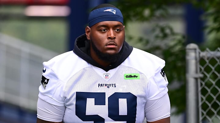 Jul 24, 2024; Foxborough, MA, USA; New England Patriots offensive tackle Vederian Lowe (59) walks to the practice field during training camp at Gillette Stadium. Mandatory Credit: Eric Canha-USA TODAY Sports