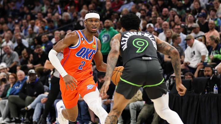 Apr 14, 2023; Minneapolis, Minnesota, USA; Oklahoma City Thunder guard Shai Gilgeous-Alexander (2) drives to the basket while Minnesota Timberwolves guard Nickeil Alexander-Walker (9) defends during the second quarter at Target Center. Mandatory Credit: Matt Krohn-Imagn Images