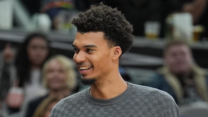 San Antonio Spurs center Victor Wembanyama stands on the sidelines.