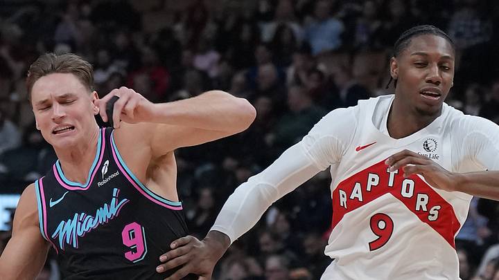 Miami Heat guard Pelle Larsson controls the ball as Toronto Raptors forward RJ Barrett tries to defend. Miami Heat guard Pelle Larsson controls the ball as Toronto Raptors forward RJ Barrett tries to defend.