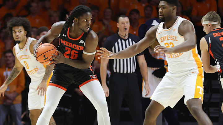 Nov 3, 2025; Knoxville, Tennessee, USA;  Mercer Bears center Armani Mighty (26) looks to moves the ball against Tennessee Volunteers forward Jaylen Carey (23) during the first half at Thompson-Boling Arena at Food City Center. Mandatory Credit: Randy Sartin-Imagn Images