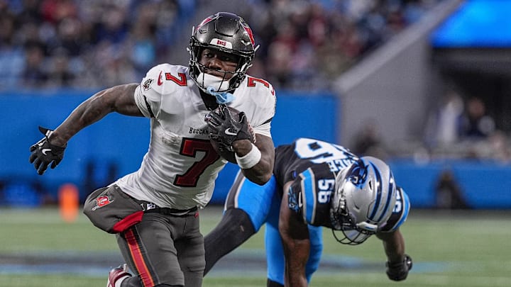 Dec 1, 2024; Charlotte, North Carolina, USA; Tampa Bay Buccaneers running back Bucky Irving (7) outruns Carolina Panthers linebacker Trevin Wallace (56) during the second quarter at Bank of America Stadium. Mandatory Credit: Jim Dedmon-Imagn Images Dec 1, 2024; Charlotte, North Carolina, USA; Tampa Bay Buccaneers running back Bucky Irving (7) outruns Carolina Panthers linebacker Trevin Wallace (56) during the second quarter at Bank of America Stadium. Mandatory Credit: Jim Dedmon-Imagn Images