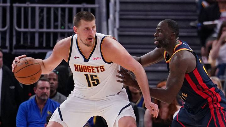 Apr 4, 2025; San Francisco, California, USA;  Denver Nuggets center Nikola Jokic (15) is guarded by Golden State Warriors forward Draymond Green (23) in the third period at Chase Center.