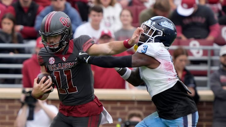 Oklahoma Sooners quarterback Jackson Arnold (11) fights off Maine Black Bears defensive back Shakur Smalls (3) during a college football game between the University of Oklahoma Sooners (OU) and the Maine Black Bears at Gaylord Family - Oklahoma Memorial Stadium in Norman, Okla., Saturday, Nov. 2, 2024. Oklahoma Sooners quarterback Jackson Arnold (11) fights off Maine Black Bears defensive back Shakur Smalls (3) during a college football game between the University of Oklahoma Sooners (OU) and the Maine Black Bears at Gaylord Family - Oklahoma Memorial Stadium in Norman, Okla., Saturday, Nov. 2, 2024.
