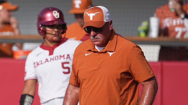 Texas Longhorns head coach Mike White walks to the pitcher's circle.