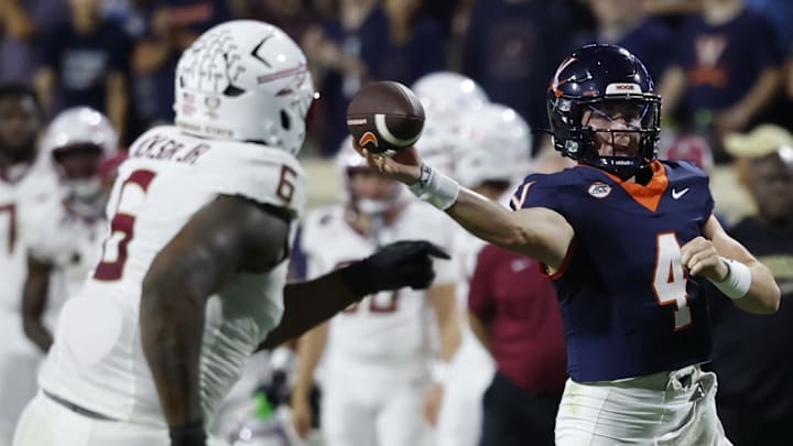 Sep 26, 2025; Charlottesville, Virginia, USA; Virginia Cavaliers quarterback Chandler Morris (4) passes the ball as Florida State Seminoles defensive lineman Darrell Jackson Jr. (6) chases at Scott Stadium. Mandatory Credit: Geoff Burke-Imagn Images