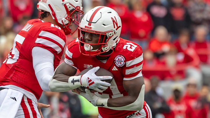 Dylan Raiola hands off to Emmett Johnson