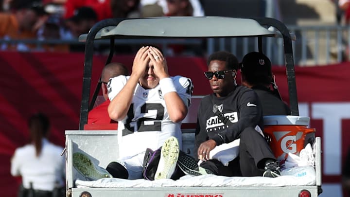 Dec 8, 2024; Tampa, Florida, USA; Las Vegas Raiders quarterback Aidan O'Connell (12) is carted off the field against the Tampa Bay Buccaneers in the third quarter at Raymond James Stadium. Mandatory Credit: Nathan Ray Seebeck-Imagn Images
