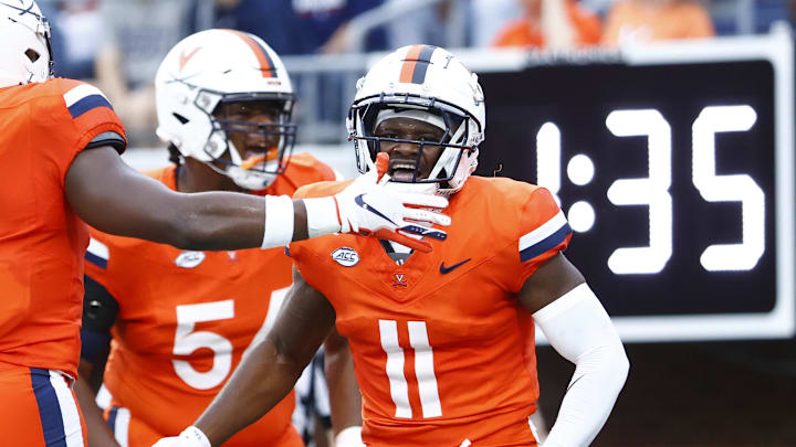 Virginia Cavaliers wide receiver Trell Harris (11) celebrates with Cavaliers running back Kobe Pace (5) after scoring a touchdown against the Richmond Spiders during the first half at Scott Stadium.
