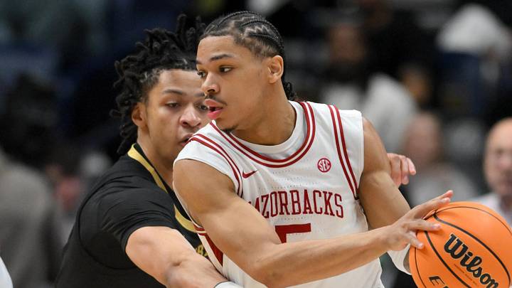 Mar 15, 2026; Nashville, TN, USA; Arkansas Razorbacks guard Darius Acuff Jr. (5) dribbles the ball defended by Vanderbilt Commodores guard Chandler Bing (7) in the second half during the men's SEC Conference Tournament Championship at Bridgestone Arena. Mandatory Credit: Steve Roberts-Imagn Images