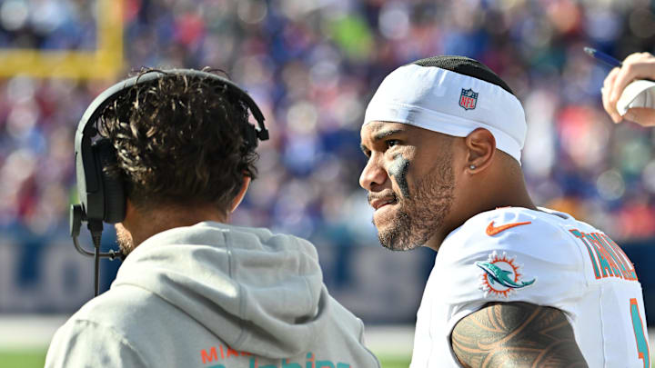 Nov 3, 2024; Orchard Park, New York, USA; Miami Dolphins quarterback Tua Tagovailoa (1) on the sidelines with head coach Mike McDaniel in the second quarter game against the Buffalo Bills at Highmark Stadium. Mandatory Credit: Mark Konezny-Imagn Images