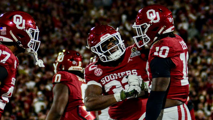 Oklahoma defensive ends Marvin Jones Jr. and R Mason Thomas celebrate with linebacker Kip Lewis celebrate after a sack against Alabama in the CFP.