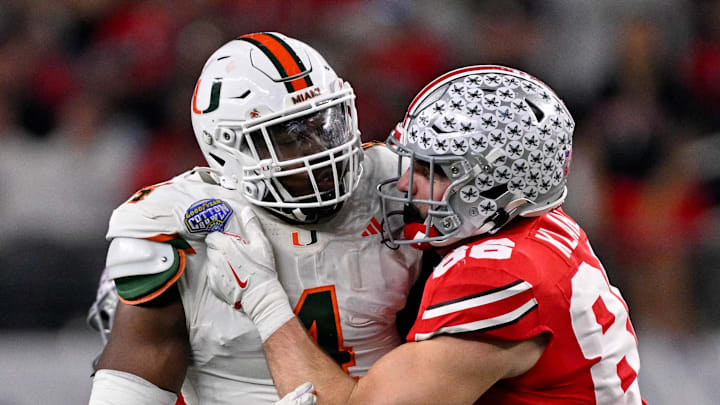 Dec 31, 2025; Arlington, TX, USA; Ohio State Buckeyes tight end Max Klare (86) blocks Miami Hurricanes defensive lineman Rueben Bain Jr. (4) during the 2025 Cotton Bowl and quarterfinal game of the College Football Playoff at AT&T Stadium. Mandatory Credit: Jerome Miron-Imagn Images