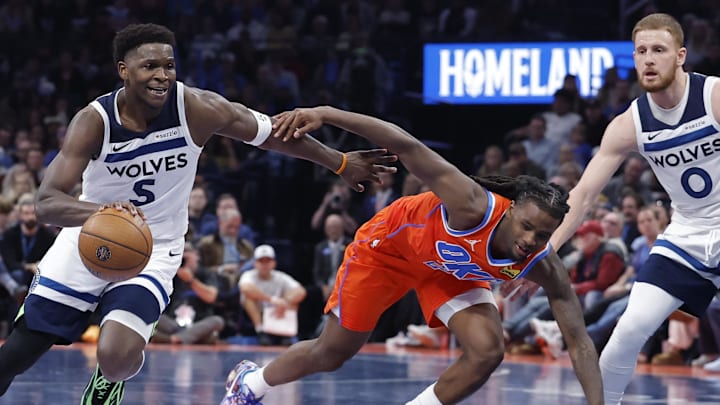 Nov 26, 2025; Oklahoma City, Oklahoma, USA; Minnesota Timberwolves guard Anthony Edwards (5) drives to the basket beside Oklahoma City Thunder guard Cason Wallace (22) during the second half at Paycom Center.