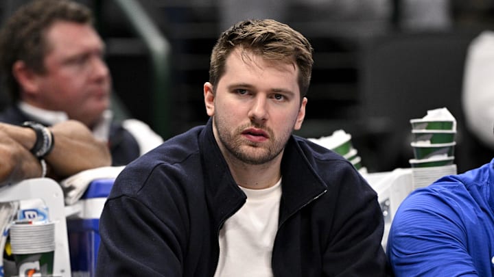 Dallas Mavericks guard Luka Doncic sits on the bench during a game.