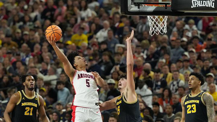 Apr 4, 2026; Indianapolis, IN, USA; Arizona Wildcats guard Brayden Burries (5) shoots against Michigan Wolverines center Aday Mara (15) in the second half during a semifinal of the Final Four of the men's 2026 NCAA Tournament at Lucas Oil Stadium. Mandatory Credit: Robert Deutsch-Imagn Images Apr 4, 2026; Indianapolis, IN, USA; Arizona Wildcats guard Brayden Burries (5) shoots against Michigan Wolverines center Aday Mara (15) in the second half during a semifinal of the Final Four of the men's 2026 NCAA Tournament at Lucas Oil Stadium. Mandatory Credit: Robert Deutsch-Imagn Images