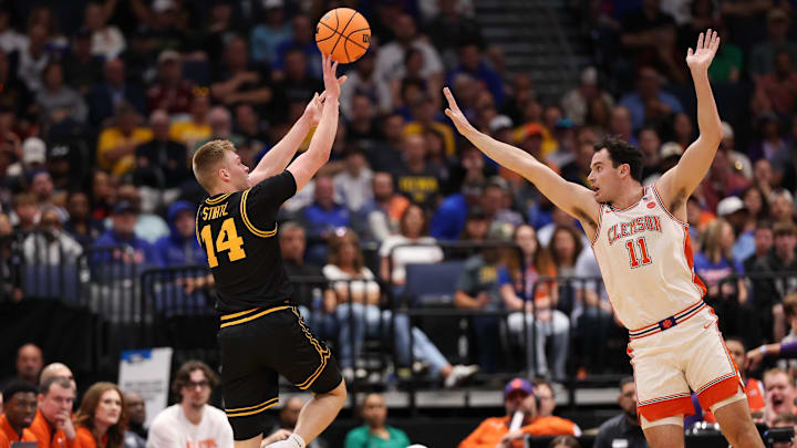 Mar 20, 2026; Tampa, FL, USA; Iowa Hawkeyes guard Bennett Stirtz (14) shoots while defended by Clemson Tigers forward/center Nick Davidson (11) in the first half during a first round game of the men's 2026 NCAA Tournament at Benchmark International Arena. Mandatory Credit: Matt Pendleton-Imagn Images
