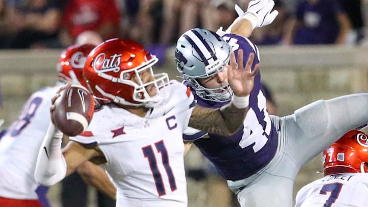 Sep 13, 2024; Manhattan, Kansas, USA; Arizona Wildcats quarterback Noah Fifita (11) passes the ball while being rushed by Kansas State Wildcats linebacker Austin Moore (41) at Bill Snyder Family Football Stadium. Mandatory Credit: Scott Sewell-Imagn Images Sep 13, 2024; Manhattan, Kansas, USA; Arizona Wildcats quarterback Noah Fifita (11) passes the ball while being rushed by Kansas State Wildcats linebacker Austin Moore (41) at Bill Snyder Family Football Stadium. Mandatory Credit: Scott Sewell-Imagn Images