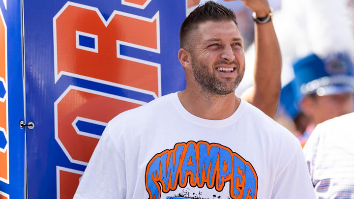Aug 31, 2024; Gainesville, Florida, USA; Former Florida Gators quarterback Tim Tebow (15) watches team introductions against the Miami Hurricanes before the game at Ben Hill Griffin Stadium. Mandatory Credit: Matt Pendleton-Imagn Images