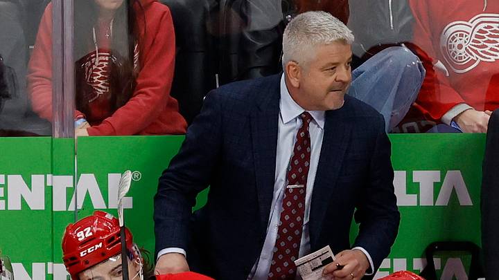 Dec 27, 2024; Detroit, Michigan, USA;  Detroit Red Wings head coach Todd McLellan  (center) stands on the bench in the third period against the Toronto Maple Leafs at Little Caesars Arena. Mandatory Credit: Rick Osentoski-Imagn Images