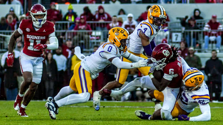 Oklahoma running back Tory Blaylock fights through a tackle against LSU.